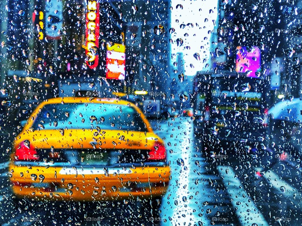 Yellow cab on the streets of New York in rain