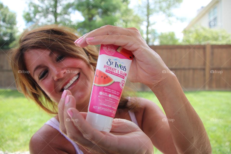 Woman holding at Ives lotion