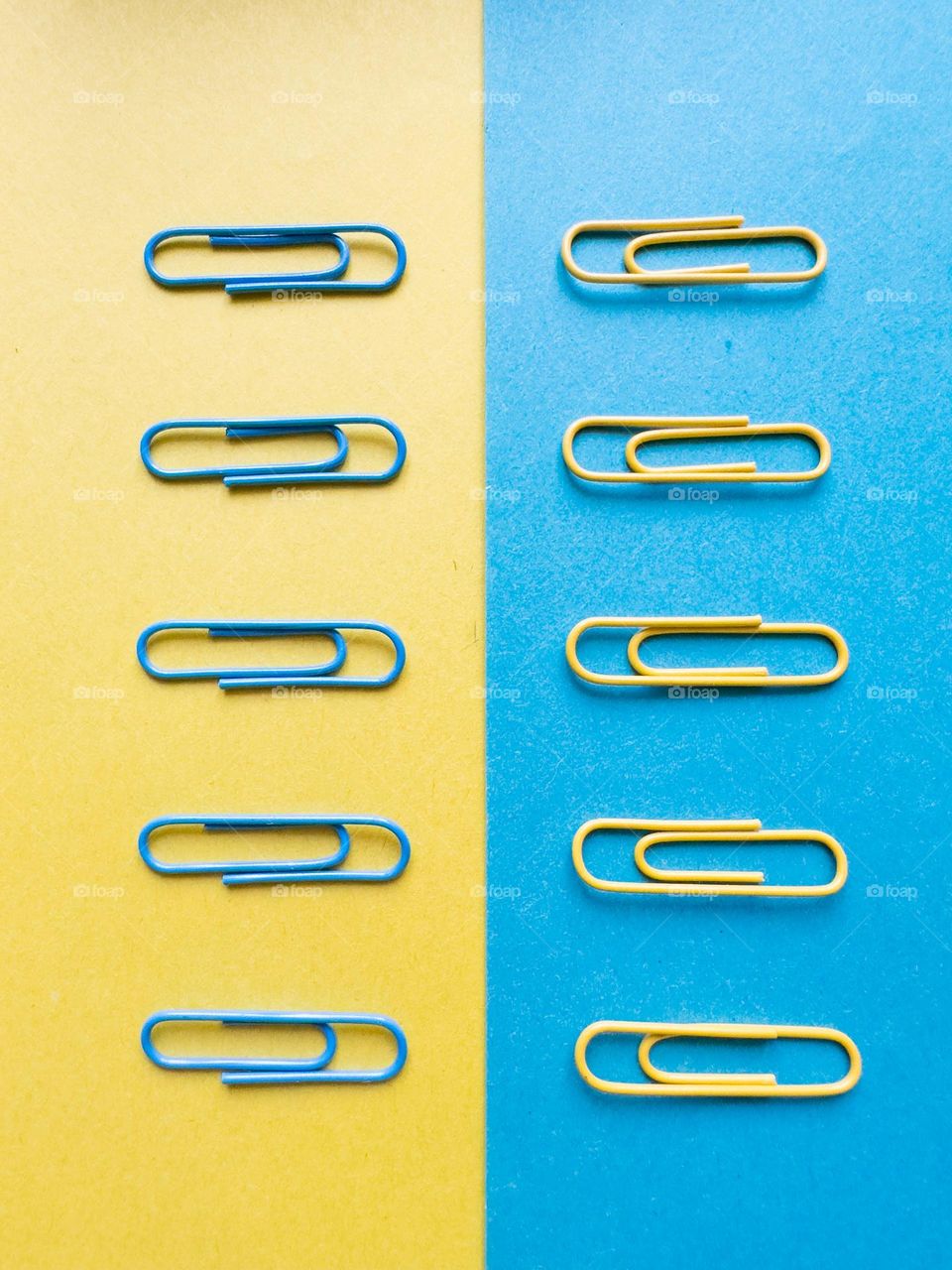 yellow and blue paper clips on colored paper