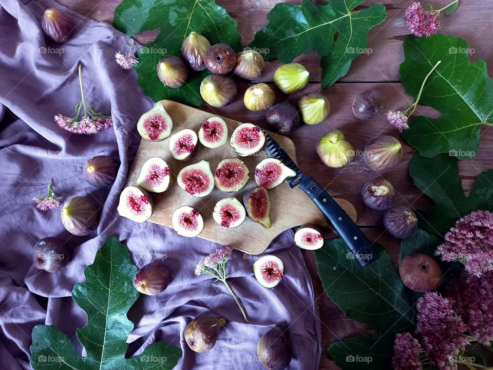 composition of figs cut on a wooden board.