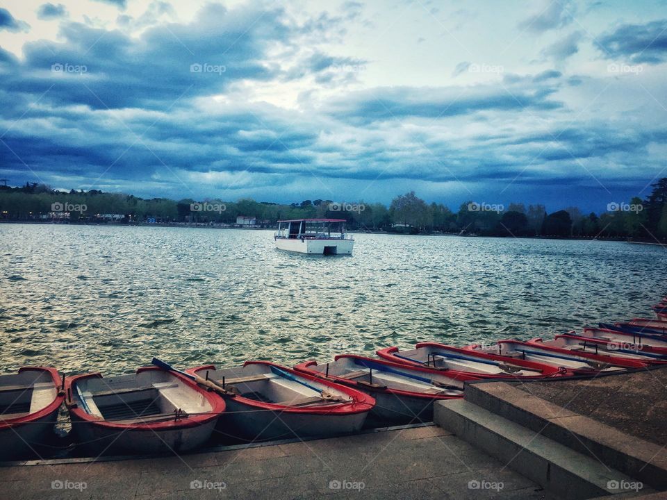 pattern of boats floating on the lake.  With a beautiful cloudy sky. Multiverse 