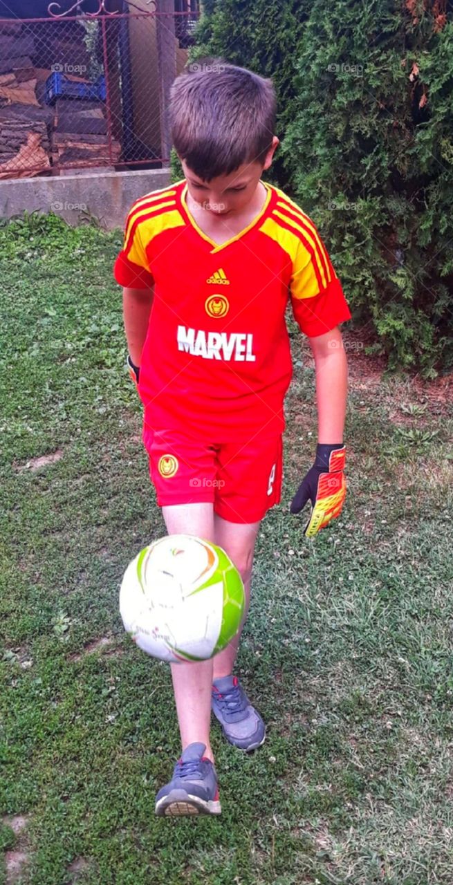 Little boy playing football