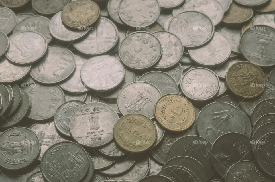 Stock pile of Hundred number 1, 10, 5 Indian rupee metal coin currency on isolated background. Financial, economy, investment concept. Banking and exchange object. closeup. Vintage tone filter effect.