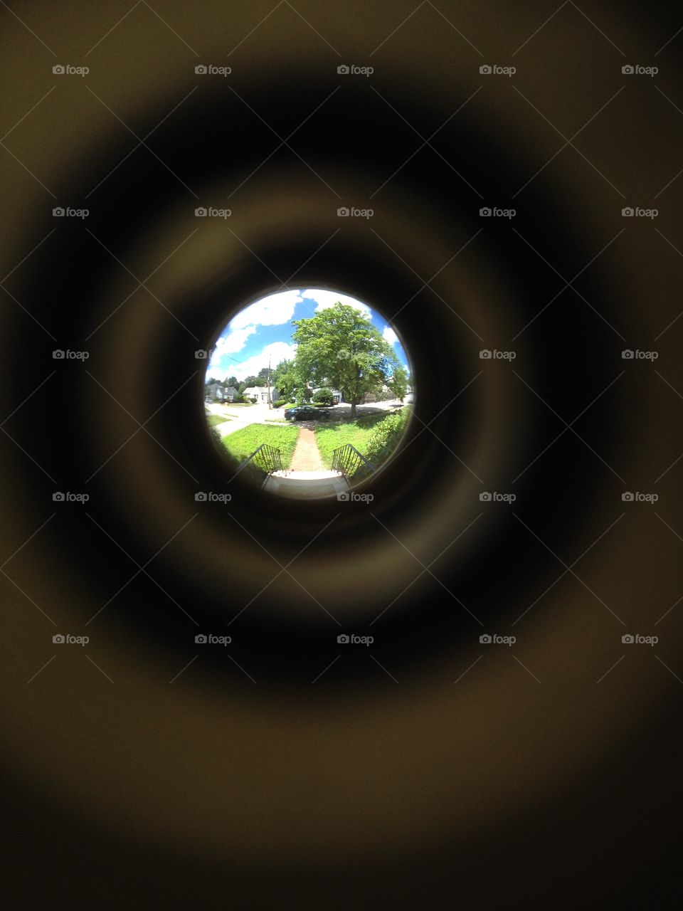 Sunny suburb through a peephole. 