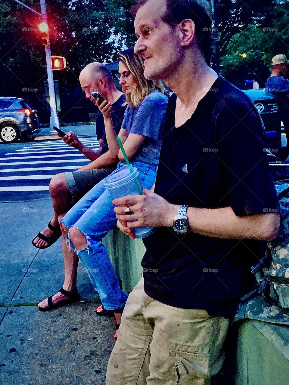“Timothy Trespas” awaits his order of Mexican food at the taco stand on “Vernon Jackson Avenue” and “48th Street” along with a few other neighborhood people after completing a long afternoon session of washing laundry. 2021. Hypnotic Productions