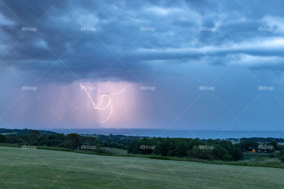 This is from af warm summer night. I was outside shooting with my camera. Clouds came by, and thunder and lightning began flashing up the landscape.