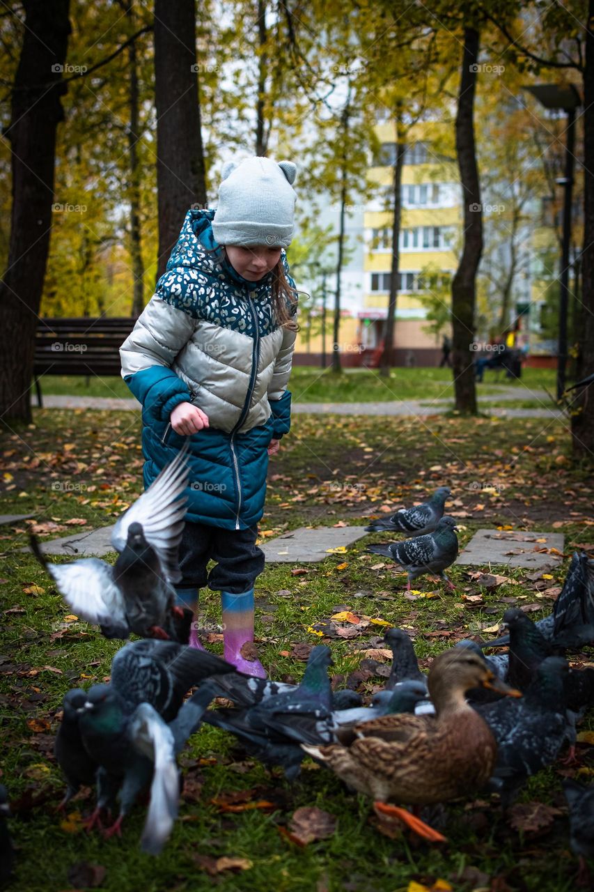 Girl with a birds in a park.