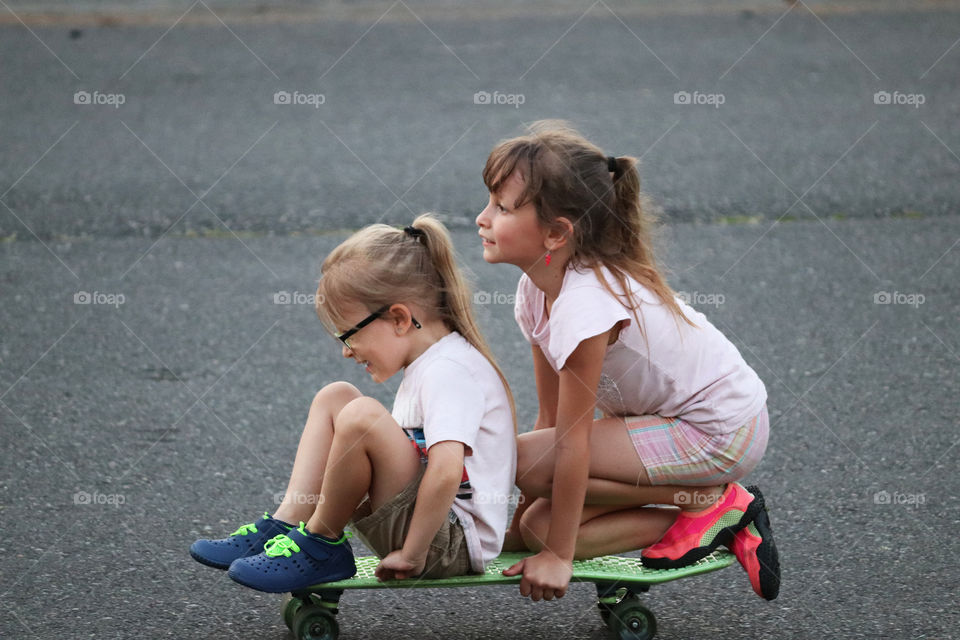 Sisters on a skateboard