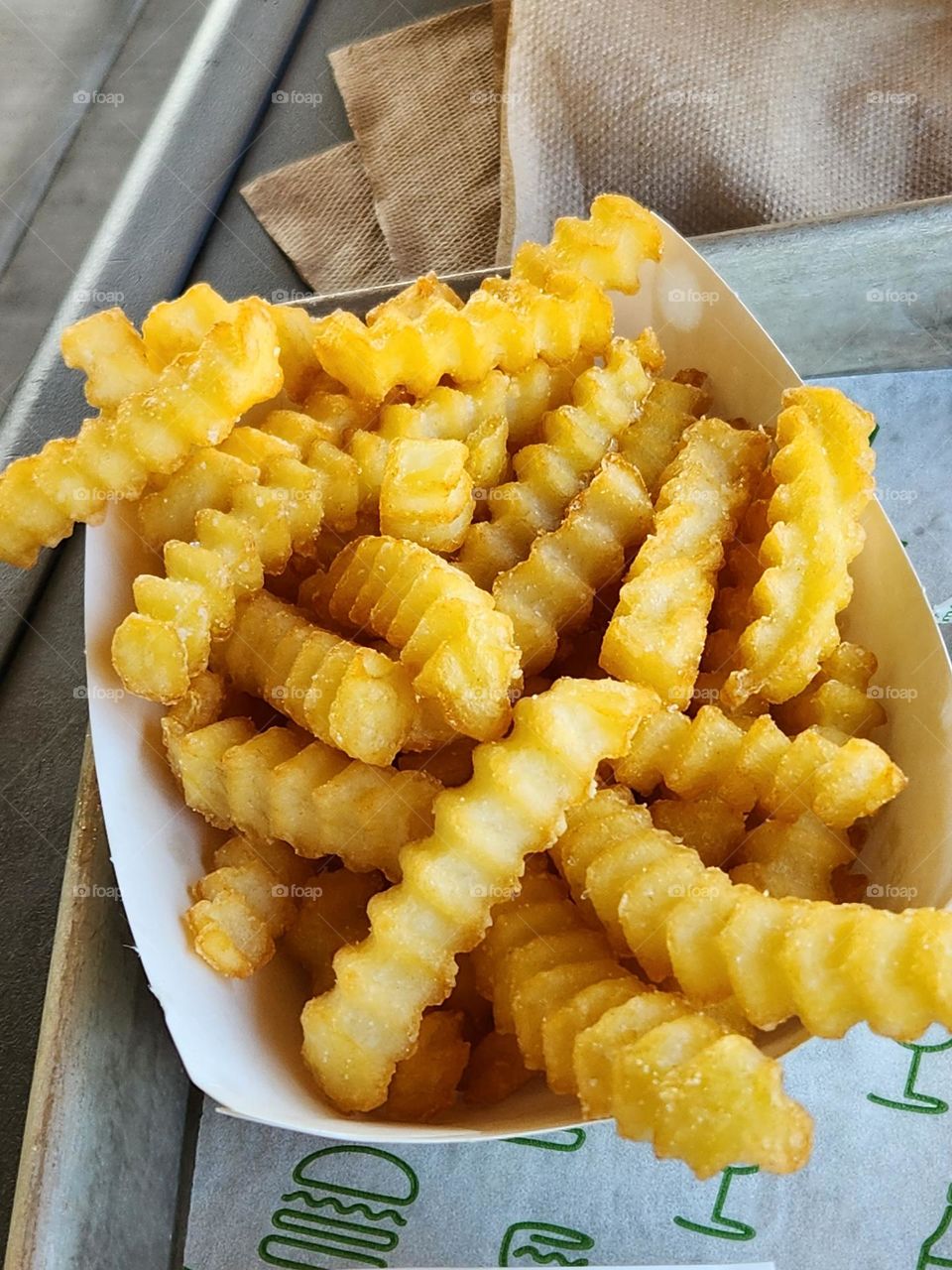 close up of crinkle cut French fries at local burger joint