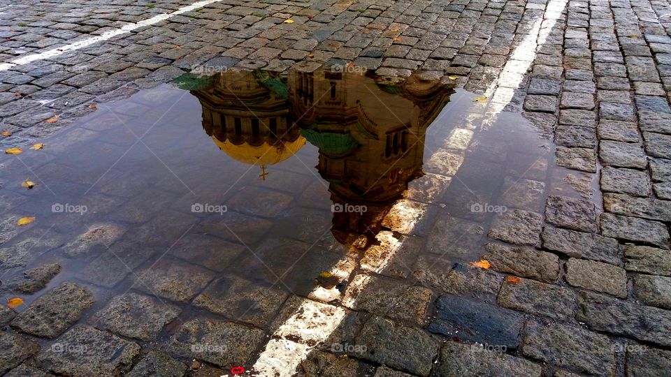 Beautiful reflection of a church in the puddle