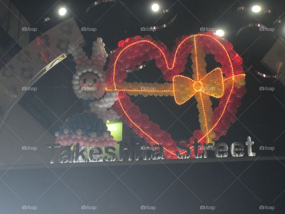 Harajuku, Tokyo, Japan. Takeshita Street Neon Hearts and Bow Sign, Lit Up at Night with Kawaii Balloon Character