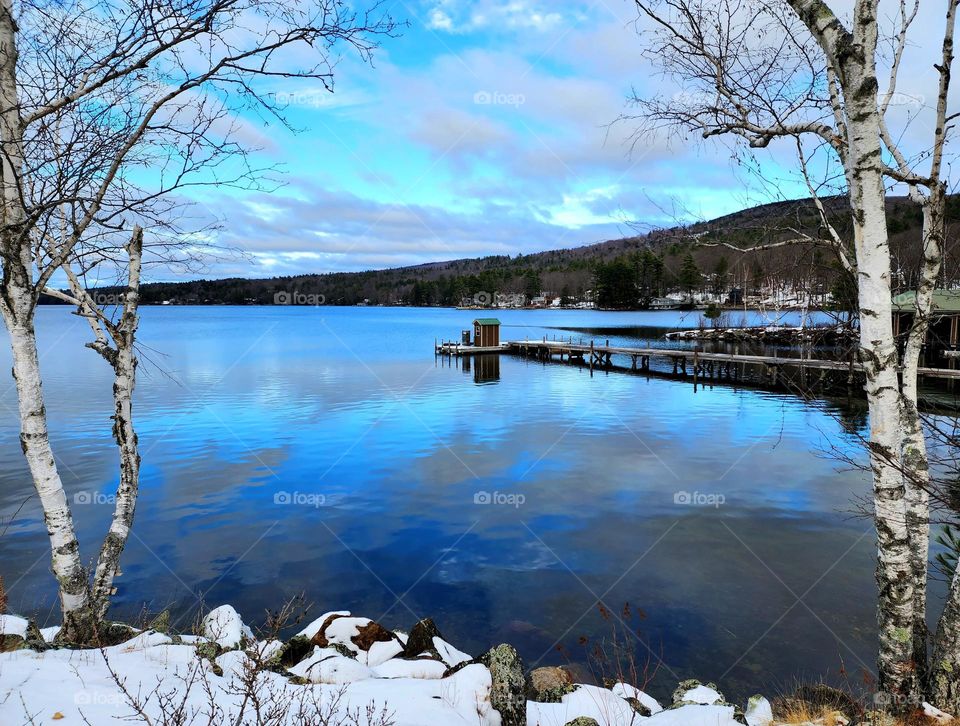 Lake Sunapee in New Hampshire on a bone chilling but clear day looks tranquil and resplendent