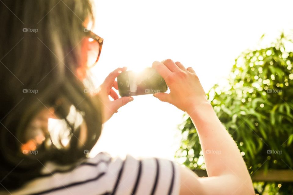 Woman taking picture with smartphone