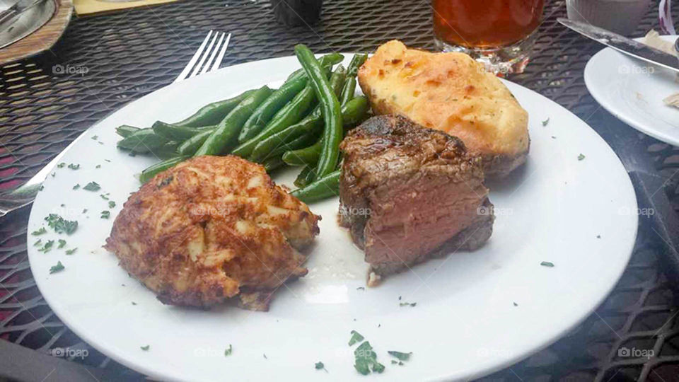 delectable dinner. Crab cake with filet mignon, green beans and twice baked potato