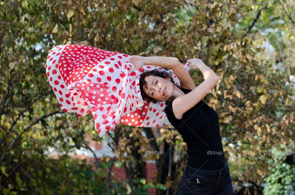 Beautiful Young Woman Dancing with Scarf Outside in Nature