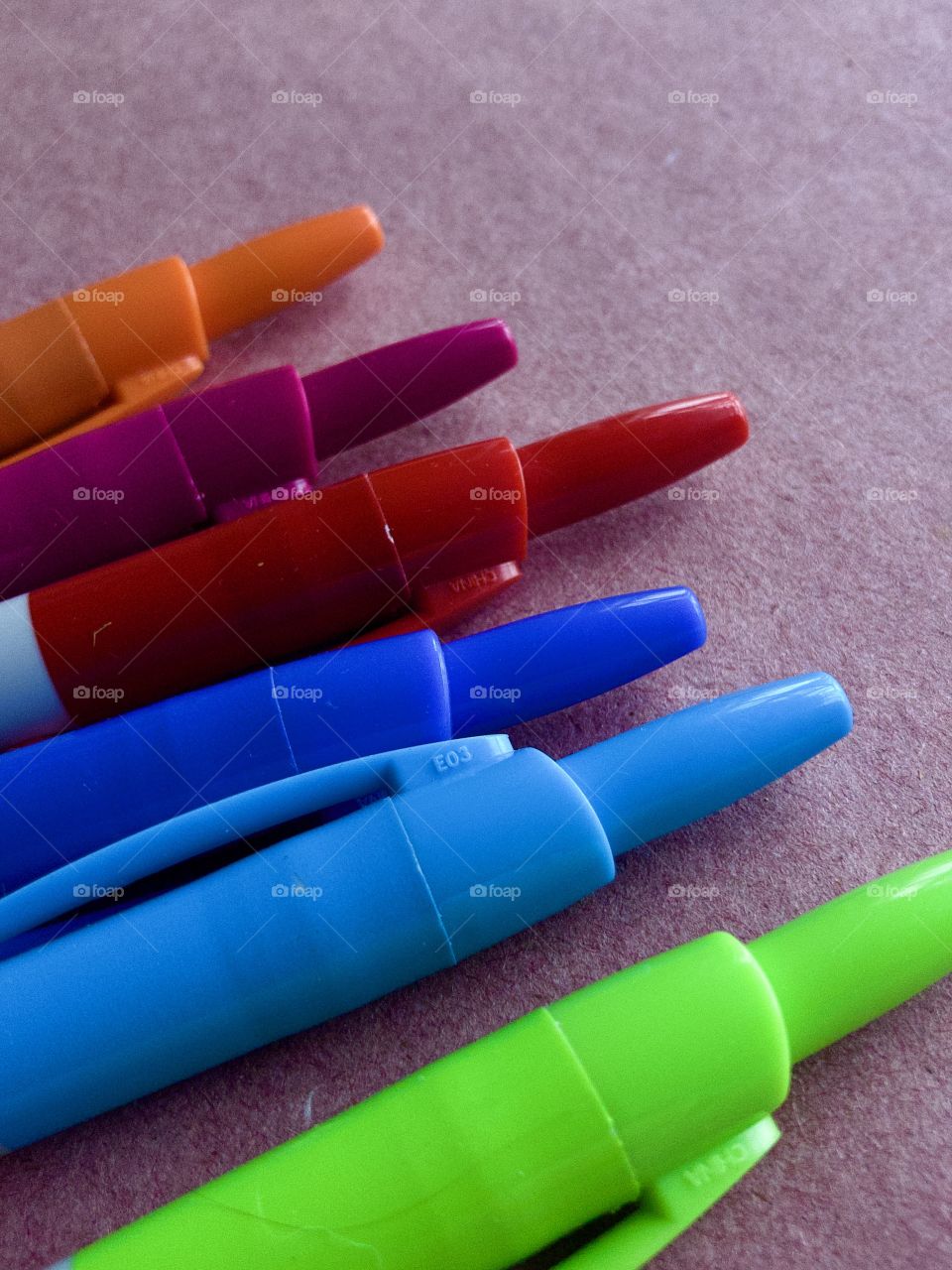 Row of colorful markers on craft paper 