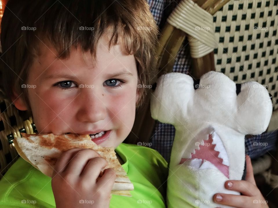 Boy Eating A Quesadilla
