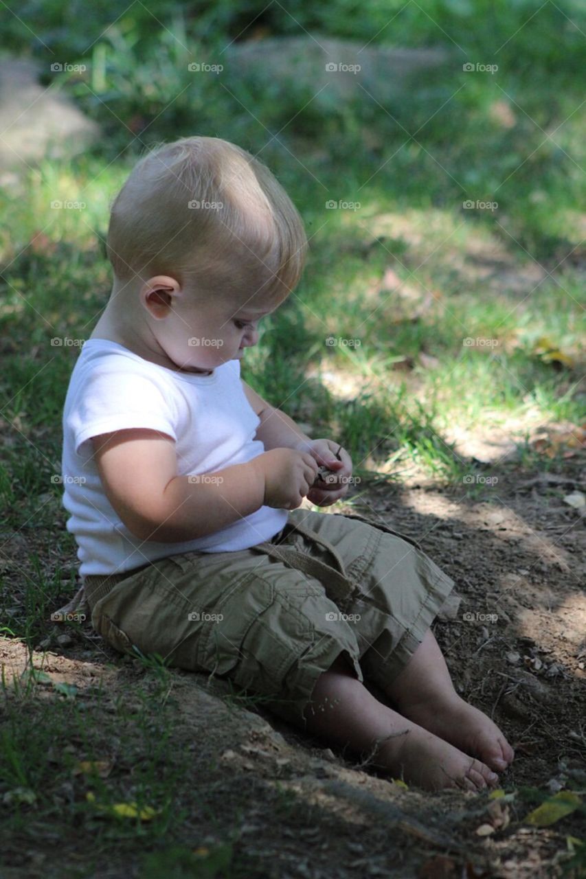 Little boy playing in garden
