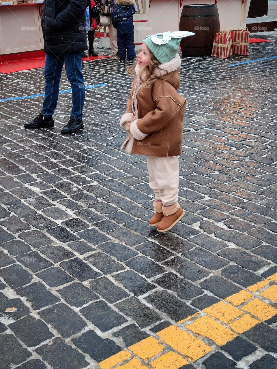 Happiness. The smile and pose of the little girl show the emotions of happiness. The little girl laughs and jumps. Photo from which the beholder has a smile on his face and happy emotions