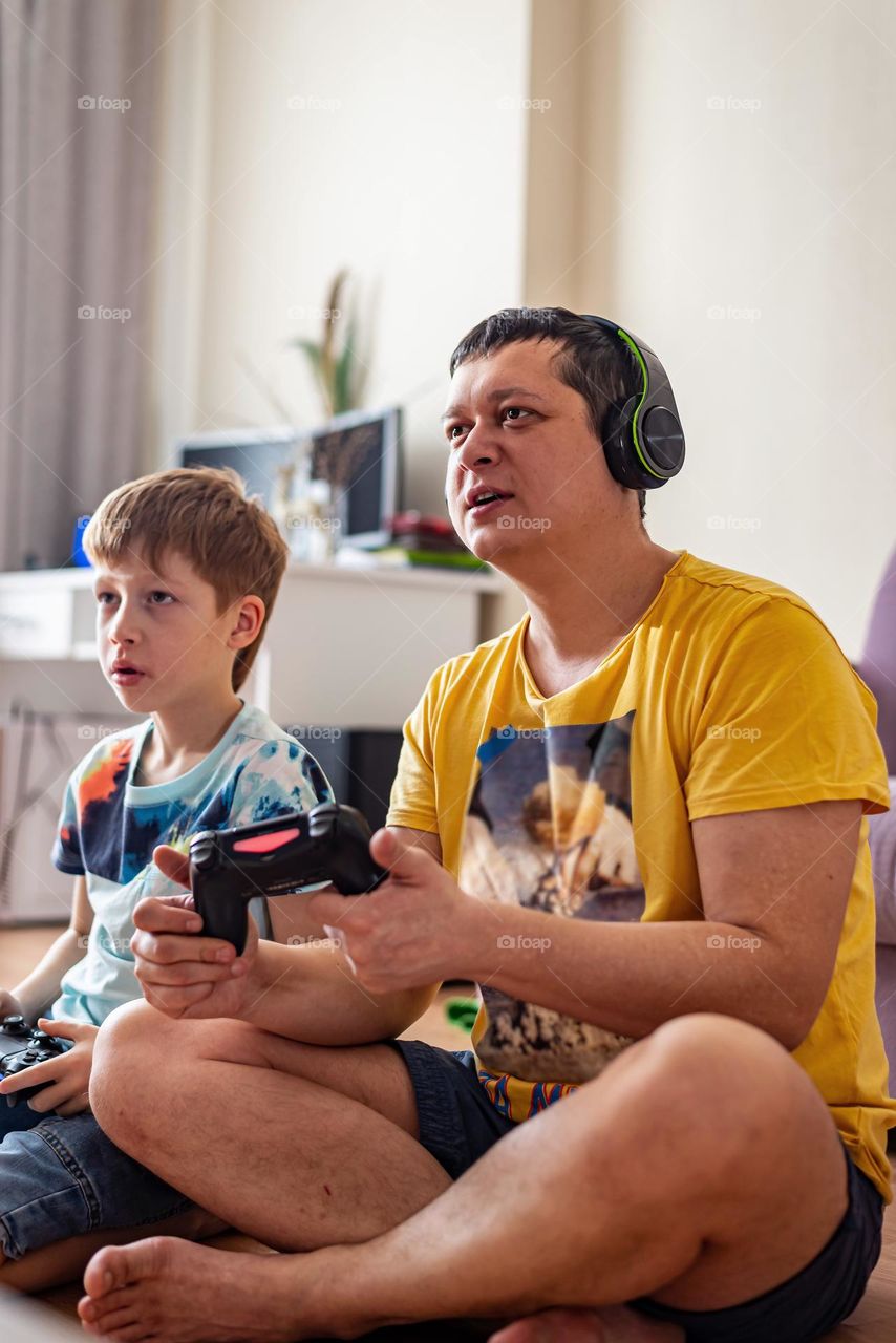 Boy and dad playing video game 