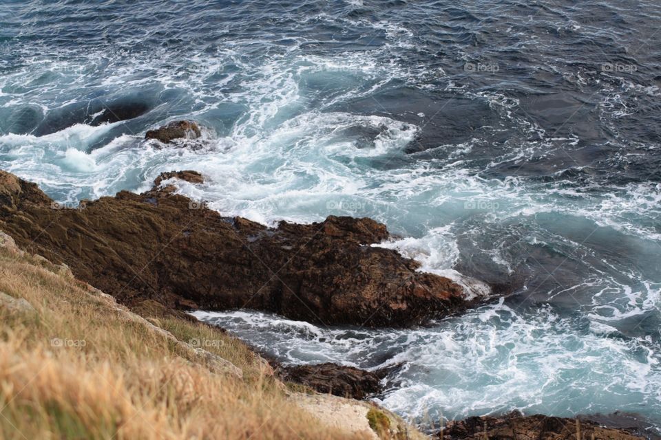 Sea swirling into rocks