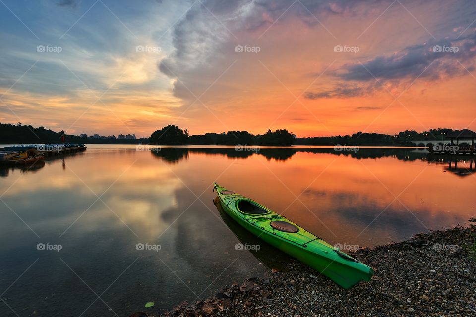 Reflections of canoe and sky during dramatic sunset