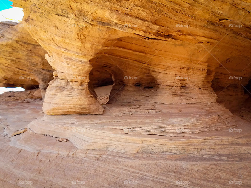 Brown and tan rock formations with columns and caves