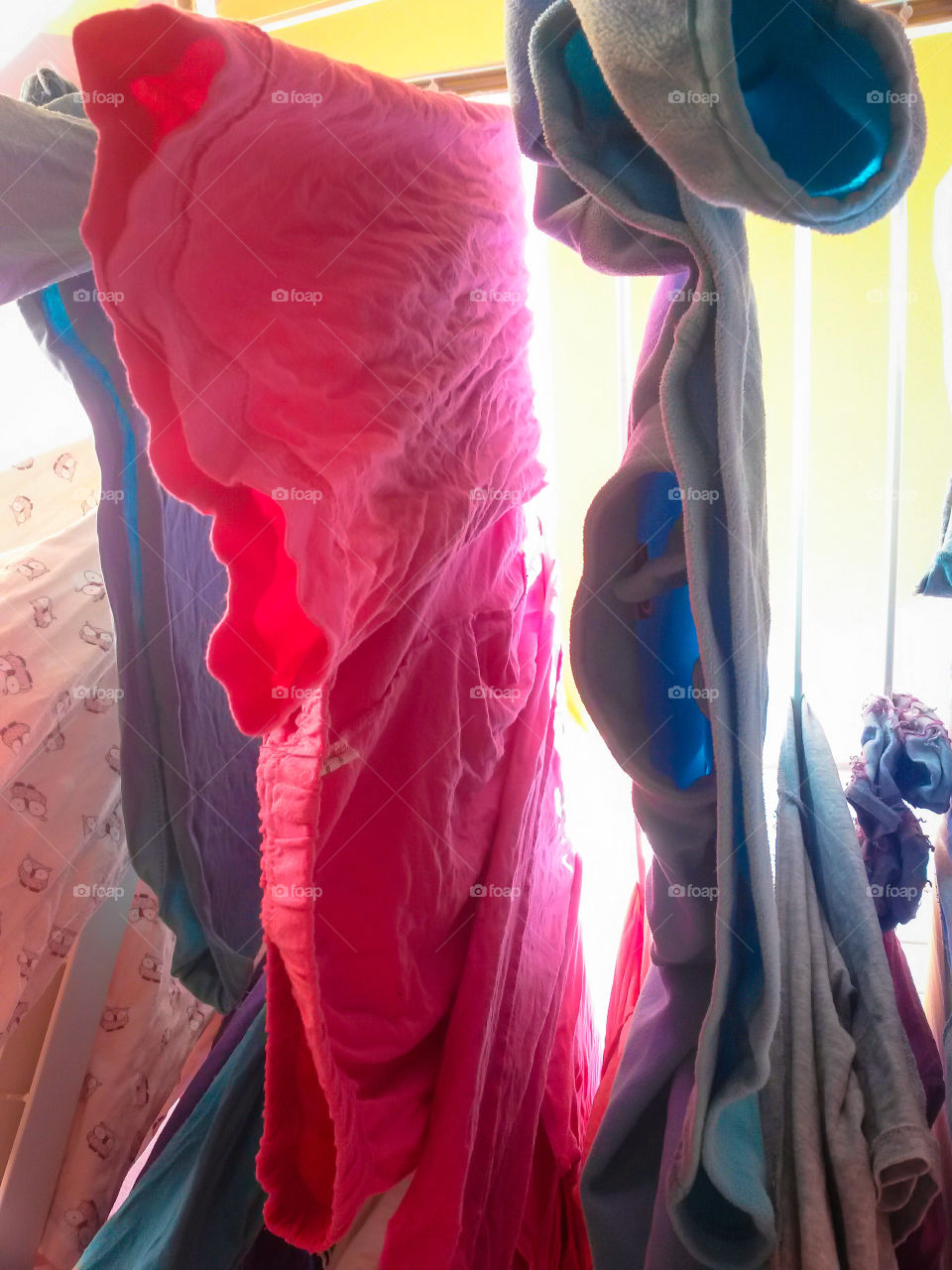 close up of colored drying clothes view from below