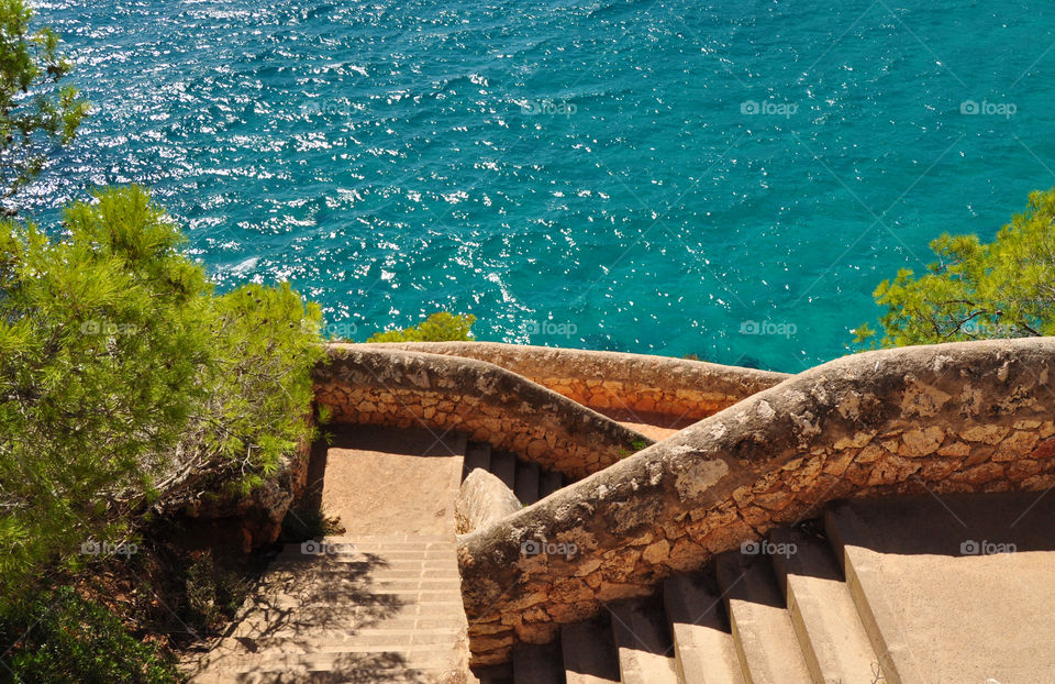 beautiful stairs to the mediterranean sea on cala romantica on mallorca balearic island in spain