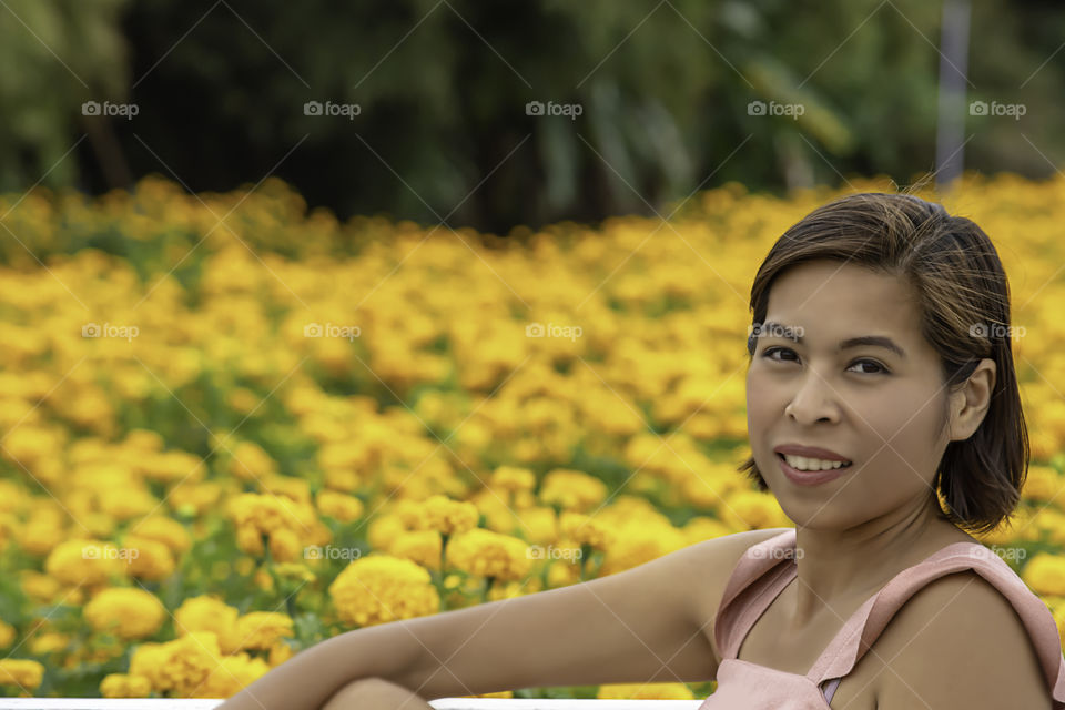 Woman in Yellow Marigold flowers garden or Tagetes erecta at Phu Rua, Loei in Thailand.