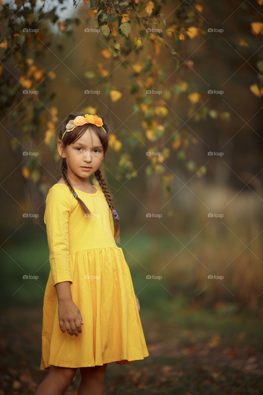 Little girl in yellow dress outdoor portrait 