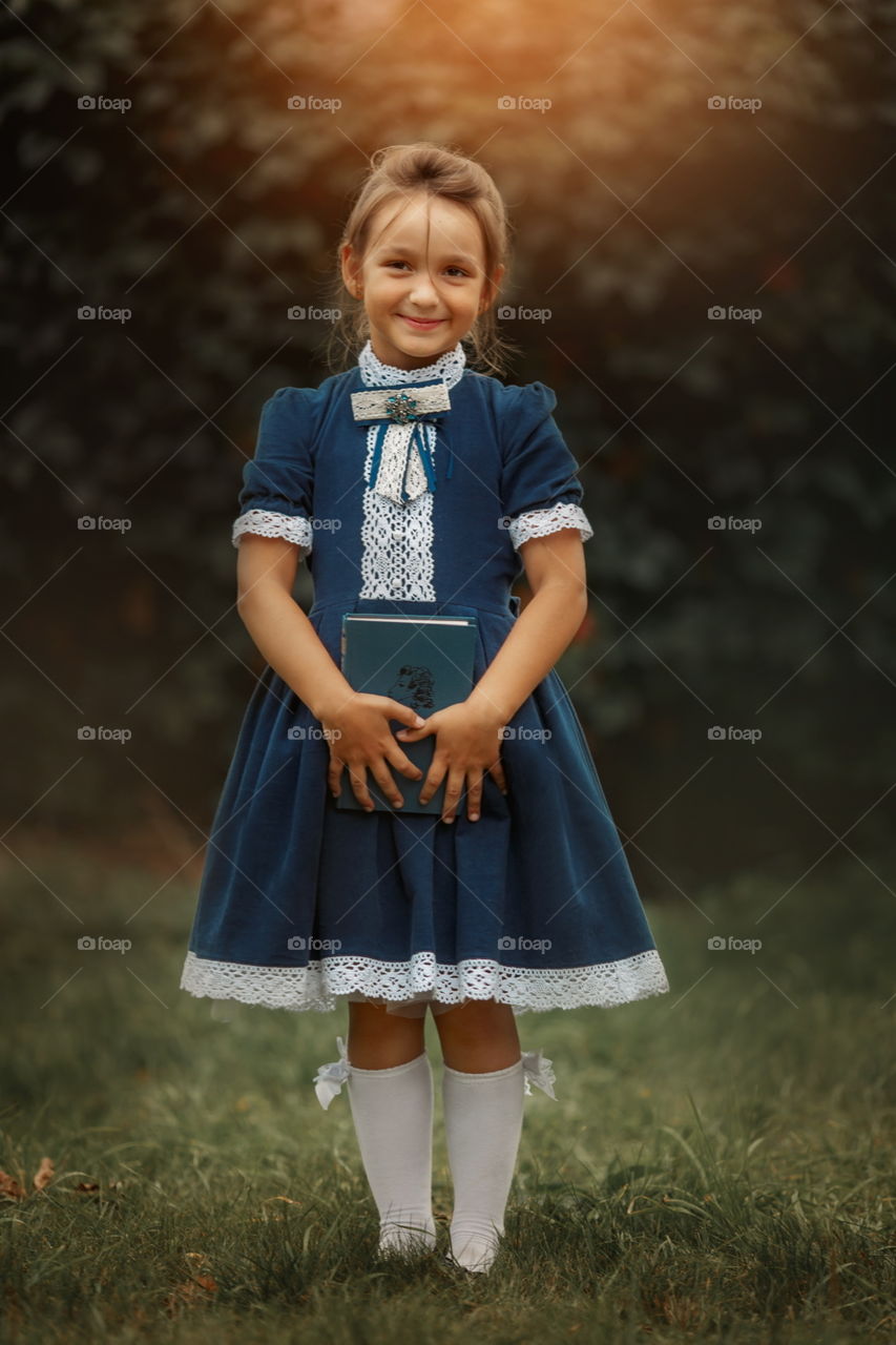 Little schoolgirl portrait at the park