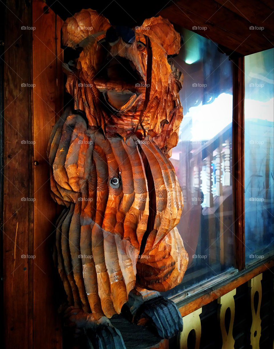 Wooden bear as a decor for a cafe showcase