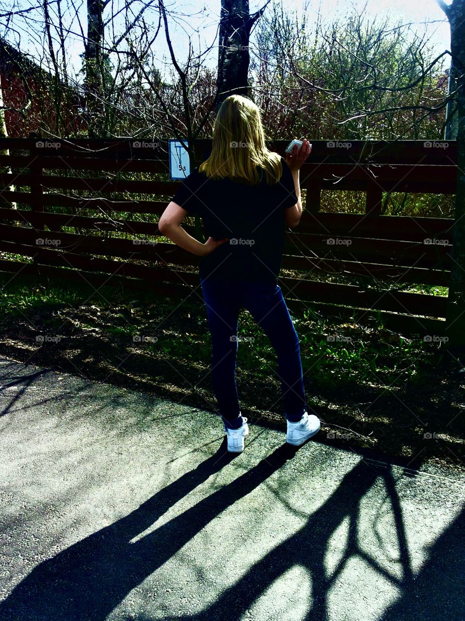 Girl by the garden fence