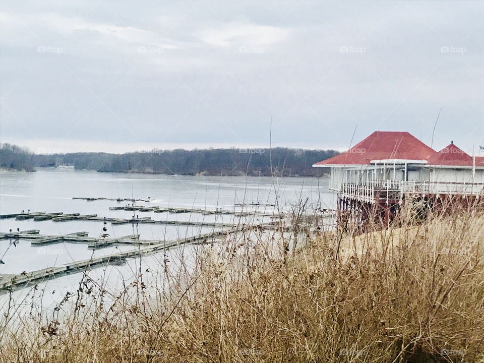 A house setting on the edge of the creek with boat docks. 