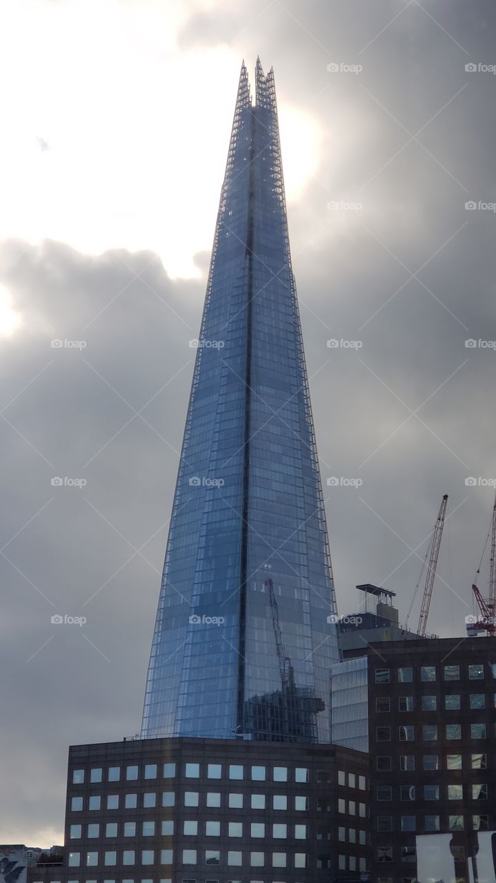 Sun through the clouds above the Shard in London.