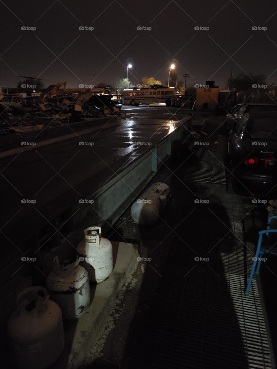 scrap yard after dark during a storm