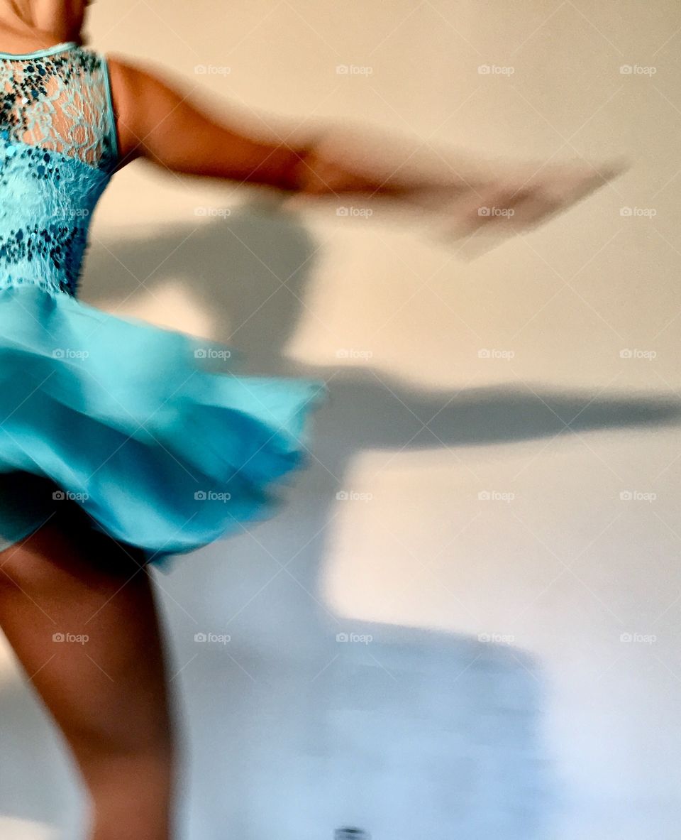 Dance in a shiny blue costume..