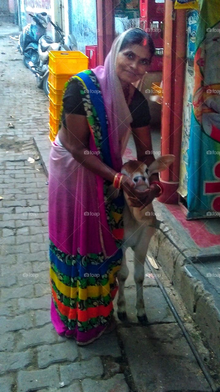 This lady in Baranas has two kids and four baby cows to comfort...