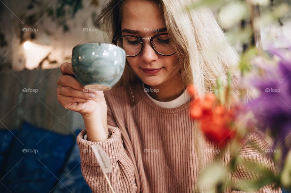 Young girl holding cup of coffee