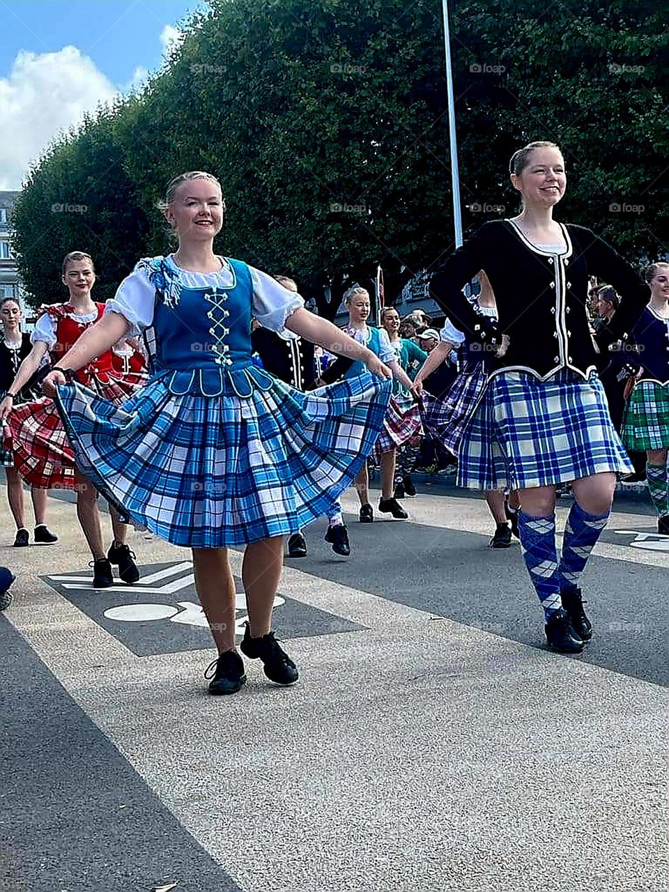 Women dancer's parade dressed in Breton traditional costumes dancing in a street of Lorient at the Inter-Celtic Festival