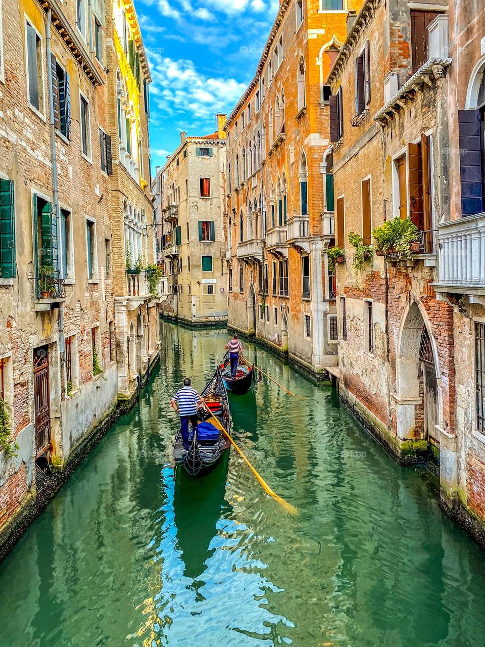 Young gondoliers in old, decaying Venice