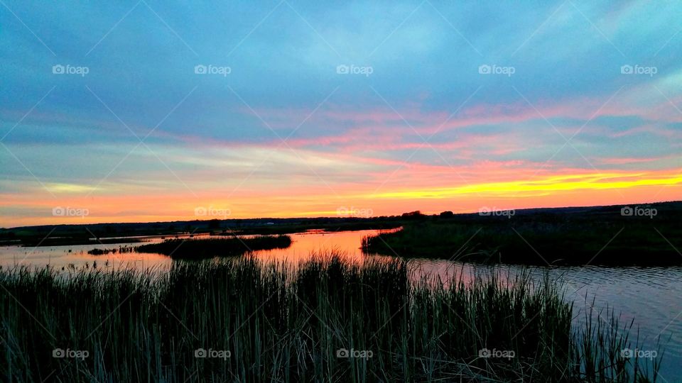 Scenic view of lake at sunset