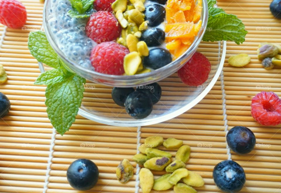 Smoothie Fresh Fruits Bowl - raspberry, blueberry,  mango, nuts and basil seeds