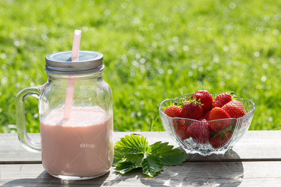 Homemade strawberry smoothie and fresh strawberries 