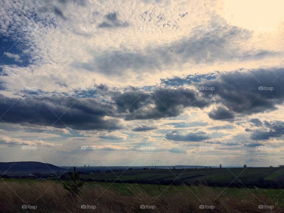 Sun shining through clouds on a flatland