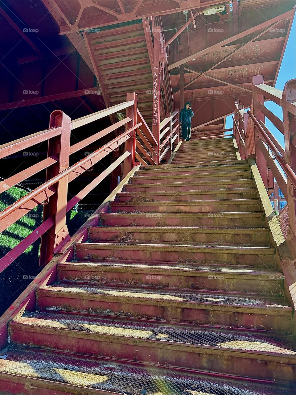 This is the red metal staircase of the “Pulaski Bridge” at “Newtown Creek” that connects LIC, Queens to “Greenpoint”, Bklyn. Its style reminds of the early modern architecture at the “Bauhaus” school of the 1930s. 2024. Hypnotic Productions