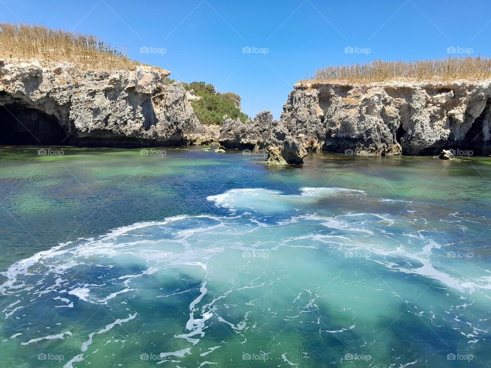 while waves rippling across the sapphire blue waters near bird Island, creating turquoise clouds.
