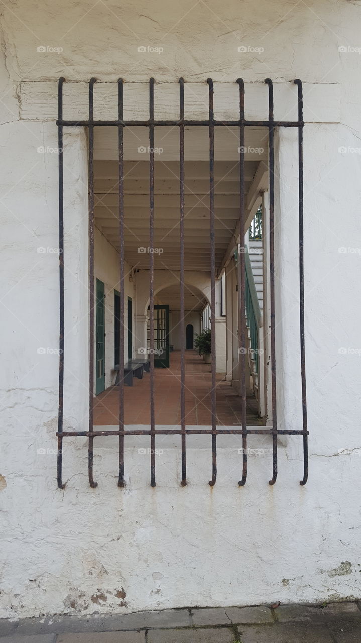 outside of an old adobe mission style building looking into the back courtyard. In Monterey, Ca