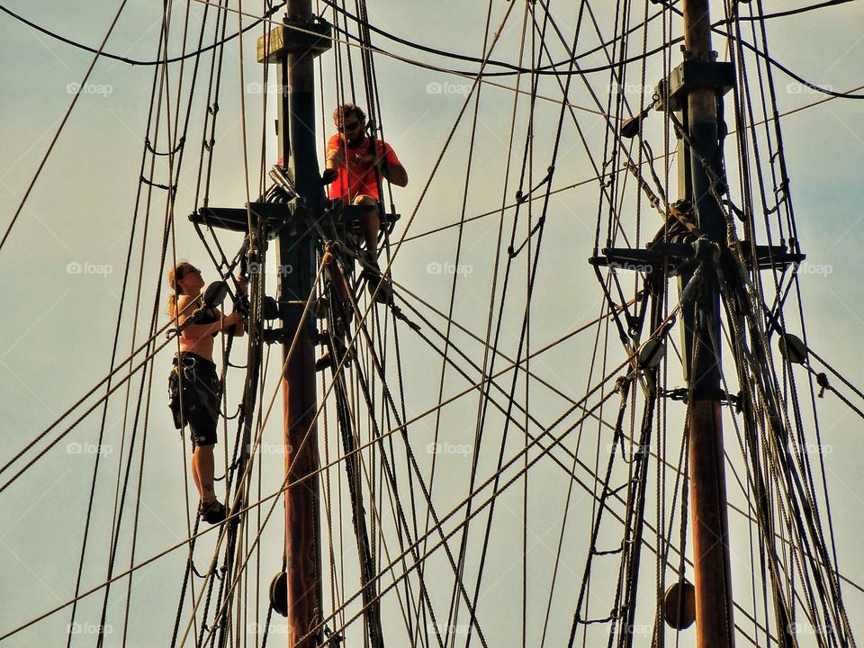 Sailors In The Rigging. Sailing Ship Rigging In The Golden Hour
